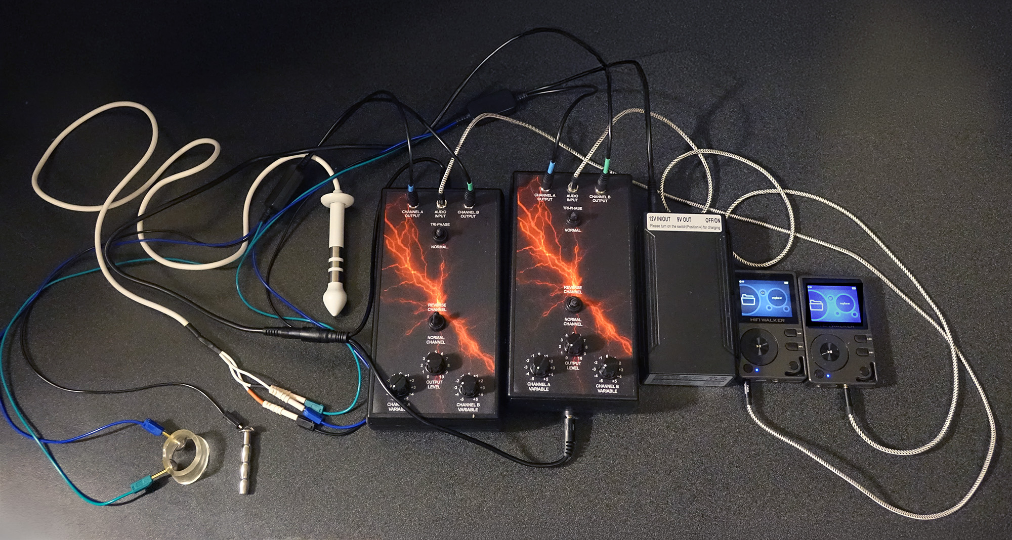 Two Tingler power boxes connected to a 12-volt battery pack using 2 MP3 players for audio input.