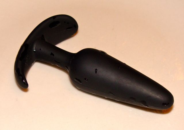 It is now time to move to something bigger. I select a big black rubber butt-plug and I decide I will not stop before I have managed to get it all the way down my throat and keep it there for five seconds. That is much harder than I thought it would be. I keep gagging and retching it out, coughing loudly. But I have sworn I would do it, so I continue and at last, with my eyes bulging and my face turning red, I manage to keep the big object entirely inside my mouth for five dreadful seconds while I keep gagging and retching around it.